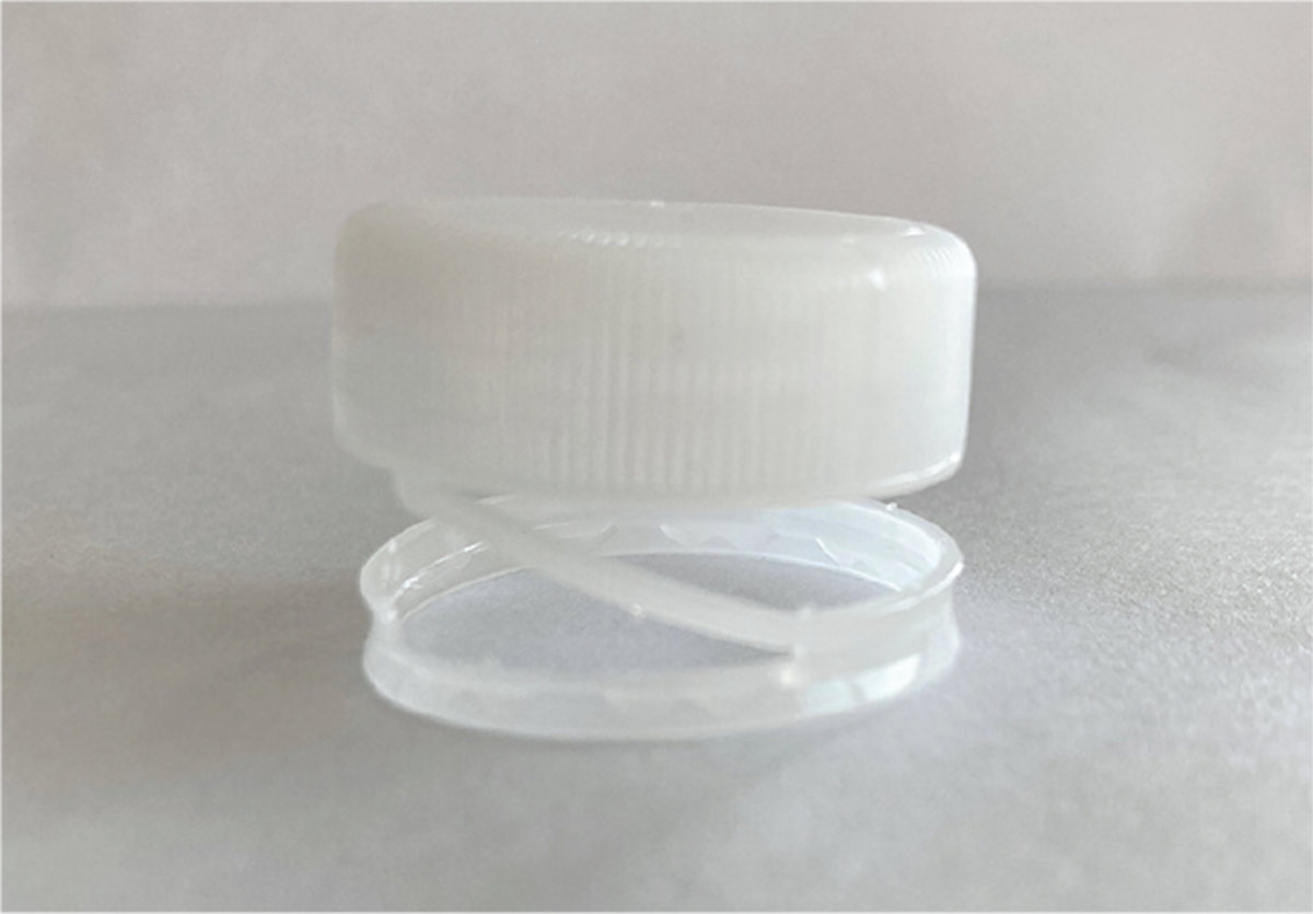 Tethered Cap Resin Reduces Necessary Material Per Unit