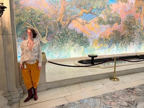Alyssa standing in front of the Dream Garden Mosaic in Philadelphia for the 2022 MXene Conference 