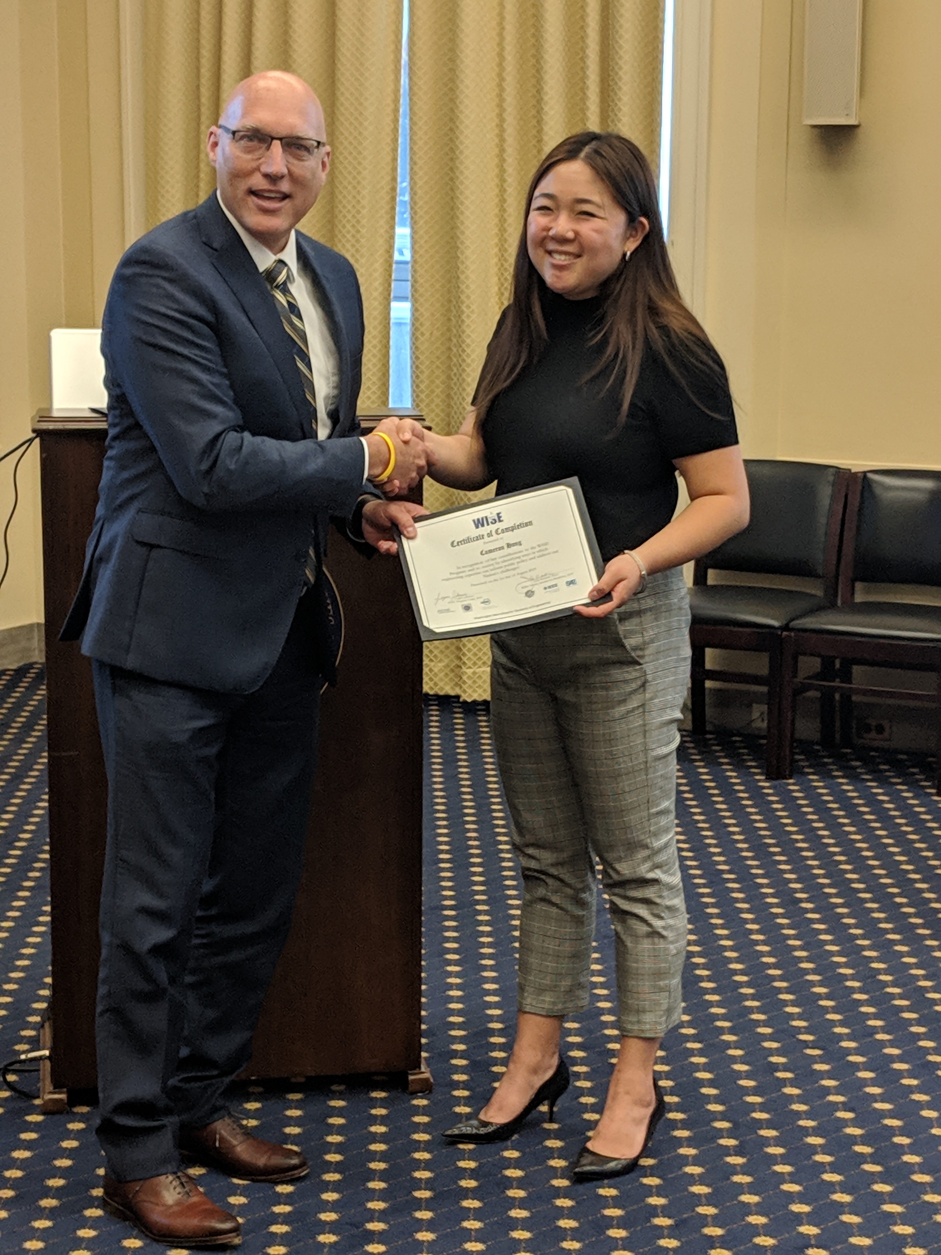 Cammie Hong receiving her certificate of completion from FMR, John Weidner