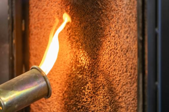 Flame-retardant material can prevent the start of a fire. Here, a material is being exposed to a direct flame to test it for flame-retardant properties.