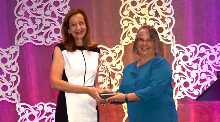 Sharon Beshouri (left) receives AIChE's 2019 AGILE Award from AIChE President Kimberly Ogden.